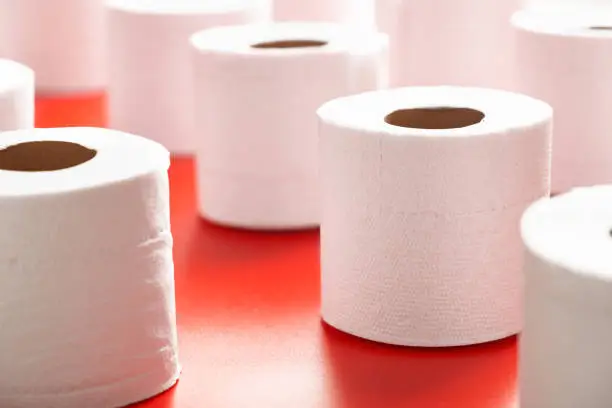 Toilet paper roll close up on a red background