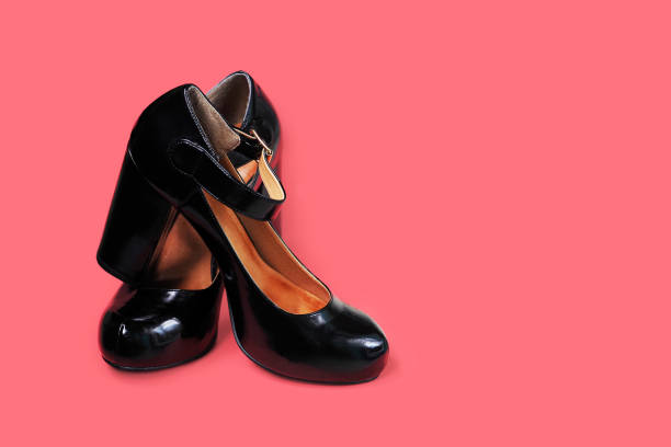 istock Black shoes on high heels on pink background, copy space 1225952329