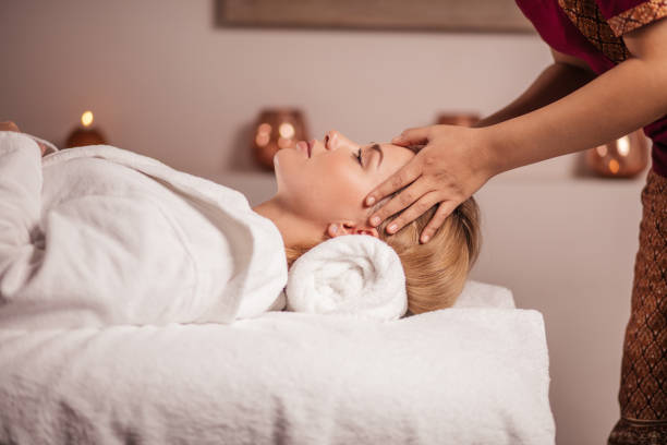 istock calm beautiful fair-haired woman getting facial massage 1225953473