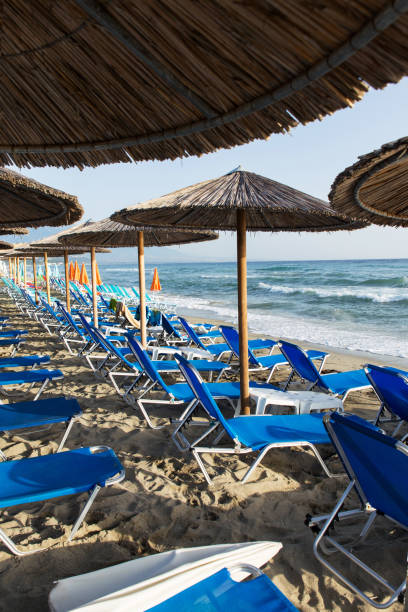 istock Tourism In Greece Grass Umbrellas With Sandy Beach 1225956450