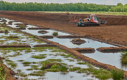 Gifhorn, Germany, May 15., 2020: Peat cutting after the drainage of a bog area