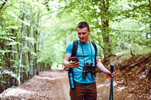 Handsome Male Using Smartphone While Enjoying Forest Exploring