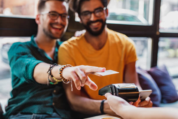 istock Gay men using contactless payment in bar 1225957294