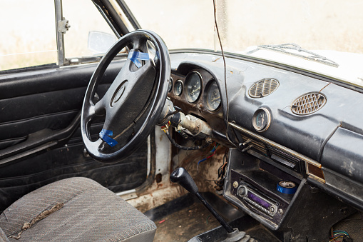 The very damaged interior of an old car from the 1980s