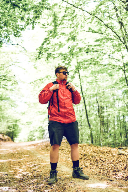 istock Young Male Walking On A Forest Footpath 1225958528
