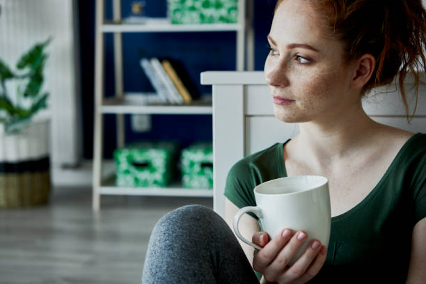 istock Nostalgic young woman and a cup of tea 1225959956