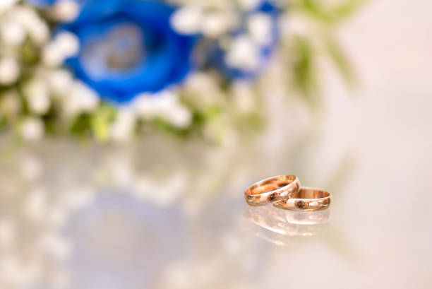wedding rings lie on a beautiful bouquet as bridal accessories