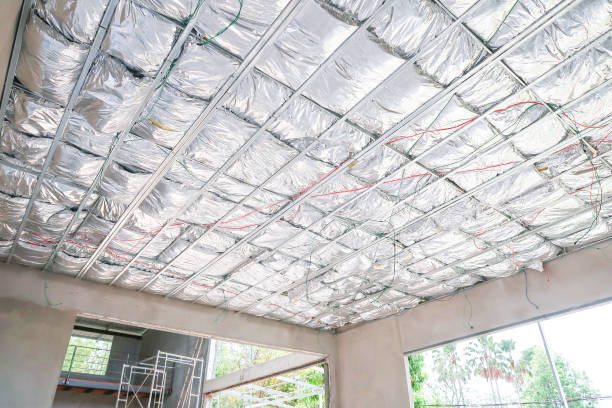 Home under construction install heat insulate the ceiling in the form of foil. stock photo
