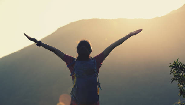 istock Successful hiker hiking on summer sunrise mountain top 1225961593
