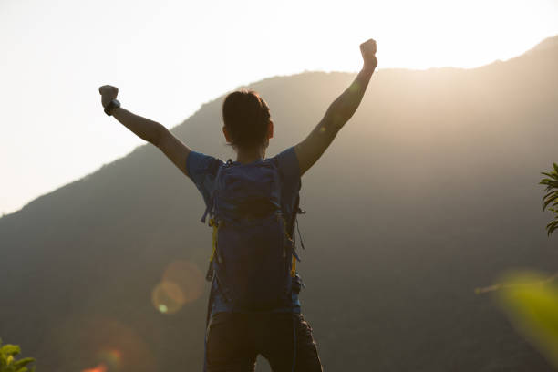 istock Successful hiker hiking on summer sunrise mountain top 1225961649