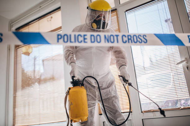 istock Man in protective suit disinfecting and spraying coronavirus infected room building 1225963437