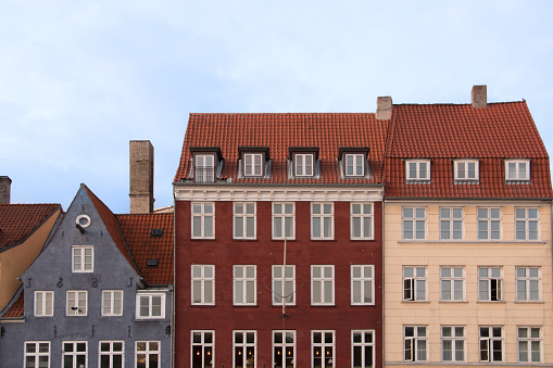 Partial view of the colorful facades of the typical buildings in front of the Nyhavn canal in Copenhagen. Urban travel