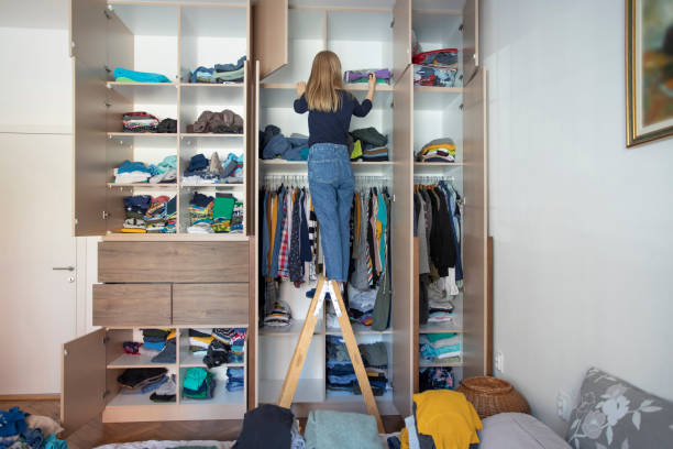 istock Woman reorganizing her wardrobe 1225965021