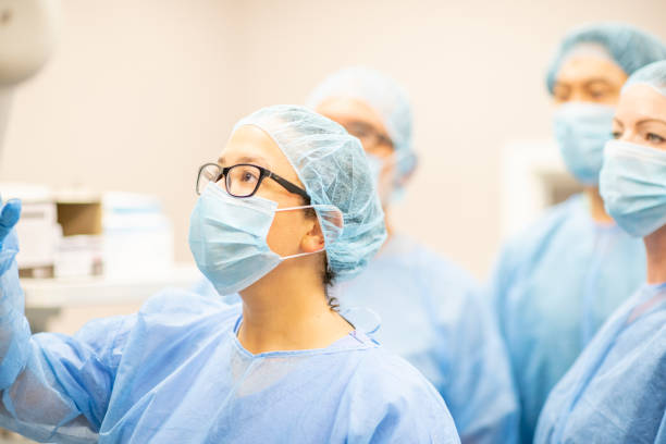 istock Group of surgeons examining a screen 1225965346