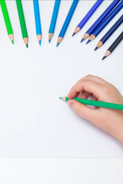 istock Kid is drawing on white blank paper. 1225967195