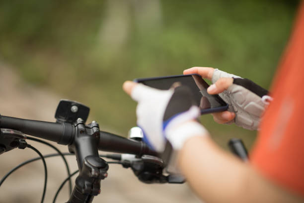 istock Cyclist use smartphone when riding mountain bike on forest trail 1225968043