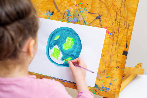 istock Little girl is drawing earth. 1225968110