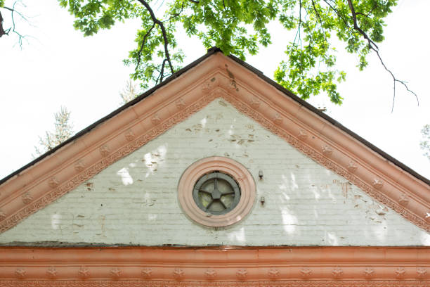 triangular roof of a vintage brick house sky