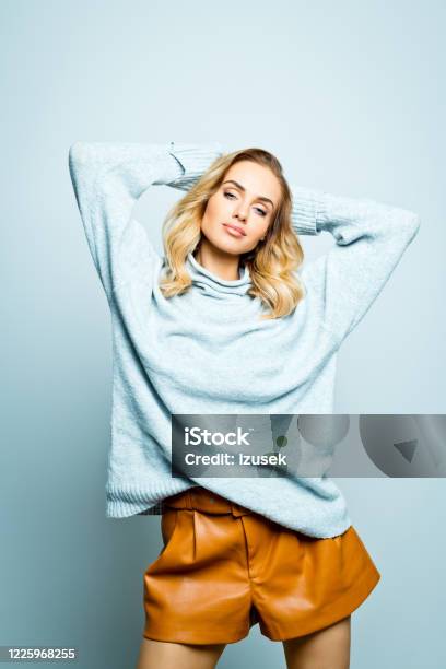 Fashion Portrait Of Beautiful Woman Wearing Grey Sweater Stock Photo - Download Image Now