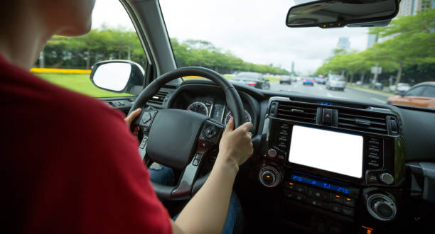 istock People hands holding steering wheel while driving car on city road 1225968584