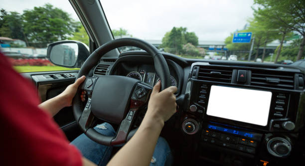 istock People hands holding steering wheel while driving car on city road 1225968795