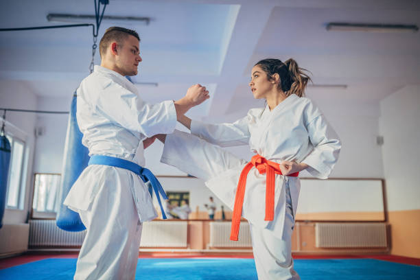 istock Young man and woman training karate together 1225969891
