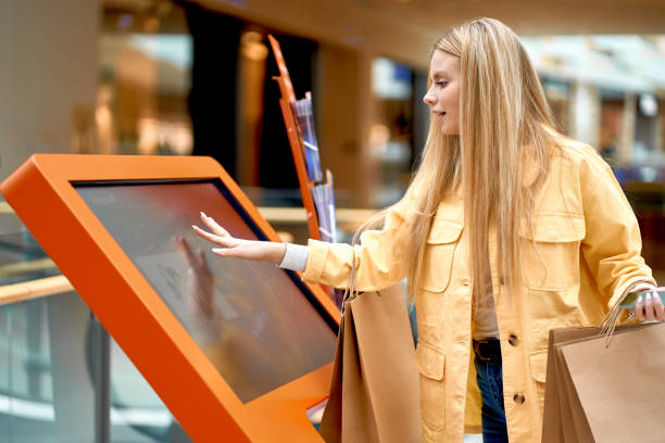 istock happy caucasian lady use search engine in shopping mall 1225969908