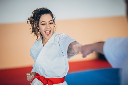 One young woman, karate student, on karate training.