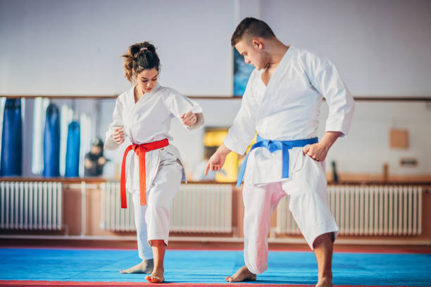 istock Karate trainer and female student on karate practice indoors 1225971815