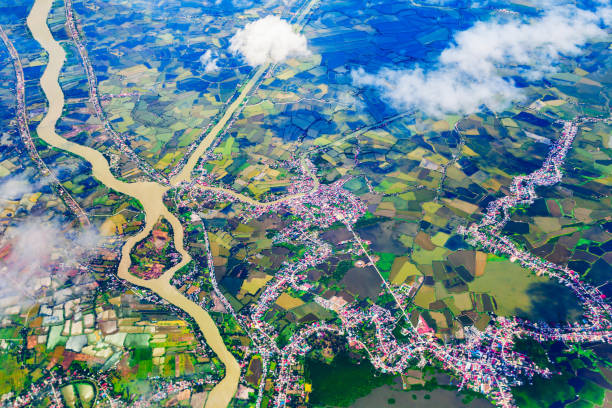 Manila suburb with small houses and rice fields aerial panoramic view from the plane, Philippines