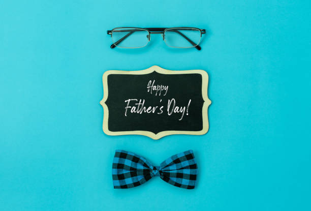 istock Table top view Happy Fathers day holiday background concept.Flat lay  gift  box for dad with accessories objects sign of season the Eyeglasses & bow tie and greeting card on blue paper.Poster season 1225973853