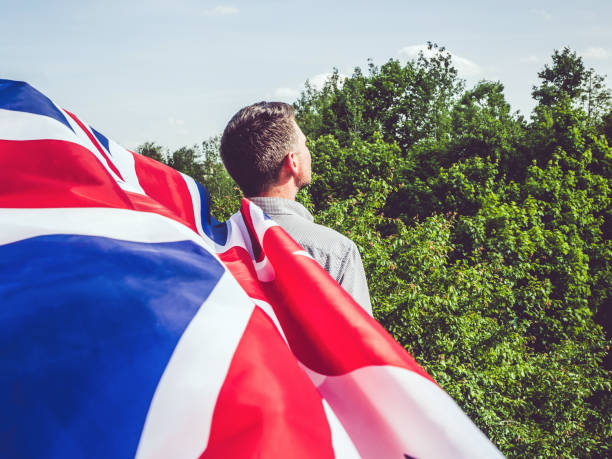 istock Attractive man holding British Flag, close up 1225974640