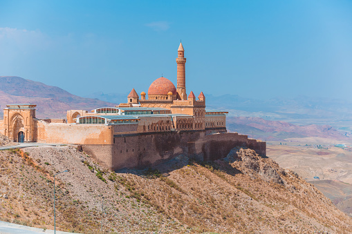 Dogubayazit, Turkey, 08.25.2014: Panoramic view of Ishak Pasha Palace on the top of the mountain. Beautiful mountain landscape. Middle East architecture