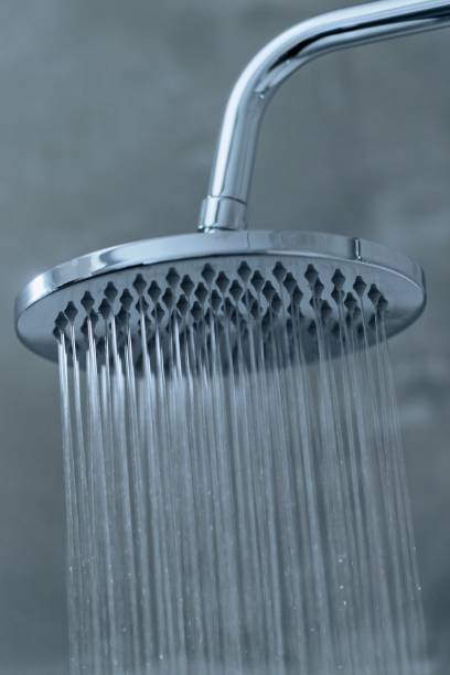 istock Close-up of water falling down from a showerhead, toned 1225978616