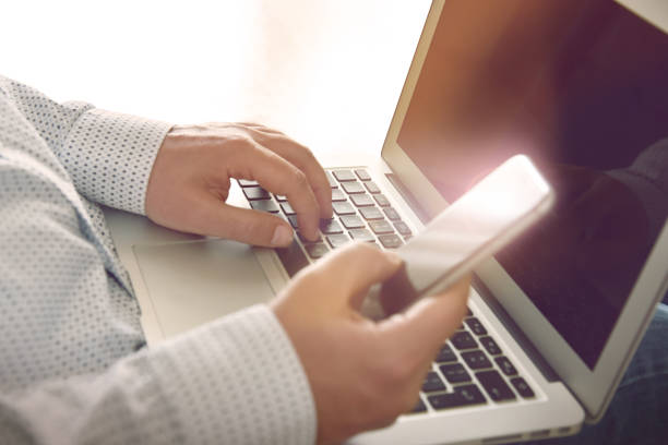 istock Businessman using smartphone and laptop. 1225980422