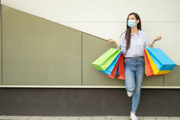 istock Woman wearing protective face mask and shopping 1225980989