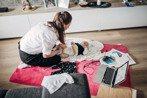 istock Single mother taking a break from work to change diaper on her baby boy 1225982347