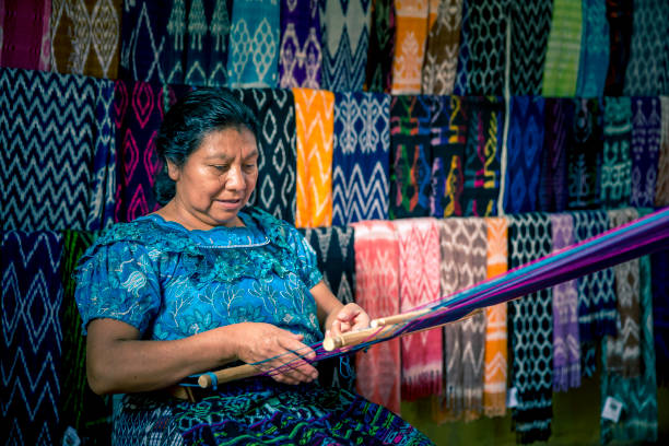 Mature woman making handmade toy on a street market