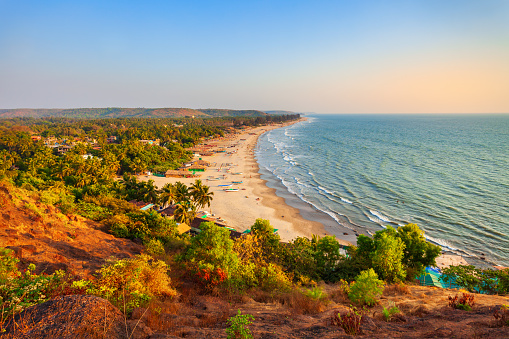 The Fort Aguada by the Sinquerim Beach, Sinquerium, Kandoli, Goa, India. The palm trees grow along the beautiful Indian ocean beach.