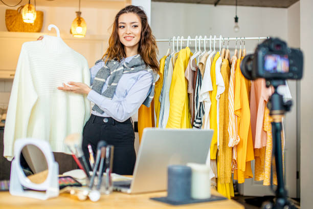 istock young smiling beauty blogger present her new blouse at camera 1225989500
