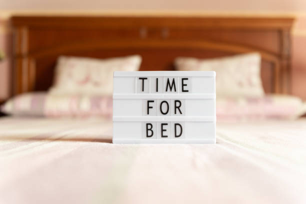 Lightbox with text: time for bed, on the bed. Lightbox with text: time for bed, on the bed, copy space. bedtime stock pictures, royalty-free photos & images