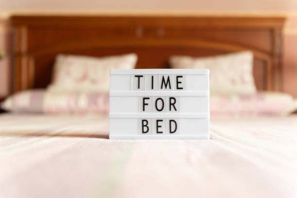 Lightbox with text: time for bed, on the bed. Lightbox with text: time for bed, on the bed, copy space. lightbox stock pictures, royalty-free photos & images