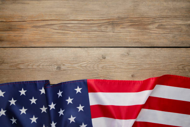 istock American flag on grey wooden background with copy space 1225991757