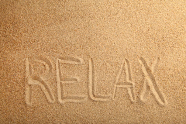 istock Inscription Relax in the sand on a tropical island. 1225991773
