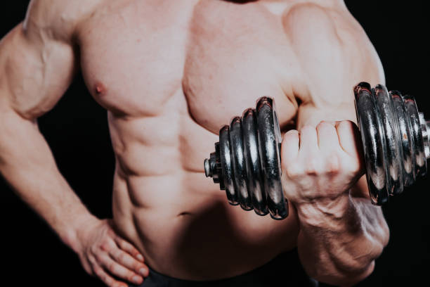 istock Sport the athlete bodybuilder build muscles dumbbells 1225992140