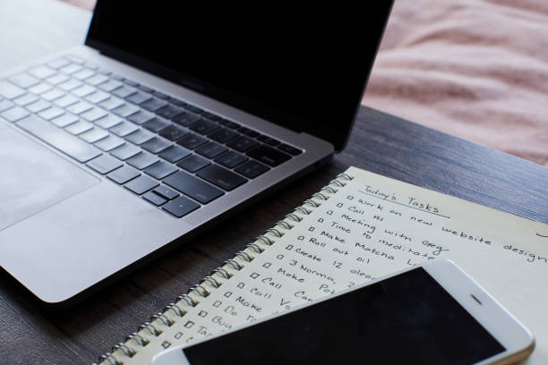 istock Cellphone sitting with a laptop and a to do list on a table 1225992201