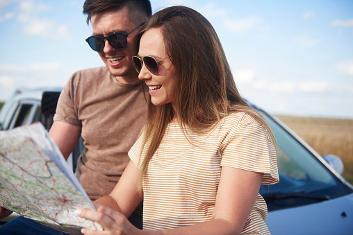 Young couple with map choosing the best road.