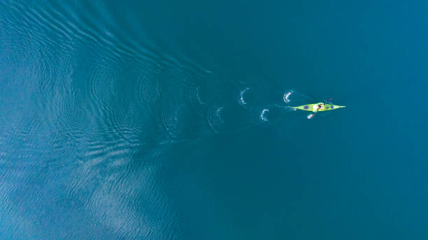 A drone shooting a kayak floating in lake