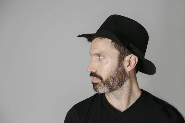 istock Profile portrait of a handsome bearded middle-aged man with hat 1225996274