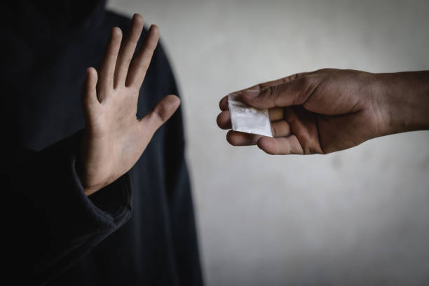 a woman making a stop gesture to drugs, stop drugs concept. international day against drug abuse. - narcotic teenager cocaine drug abuse imagens e fotografias de stock